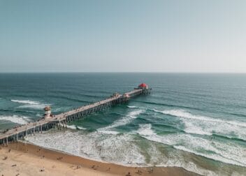 People Walking and surfing on Huntington Beach, CA, United States