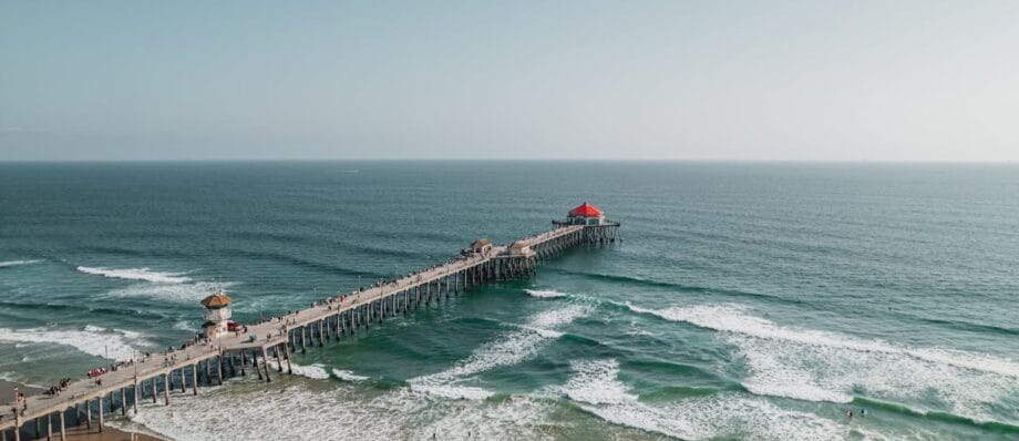 People Walking and surfing on Huntington Beach, CA, United States